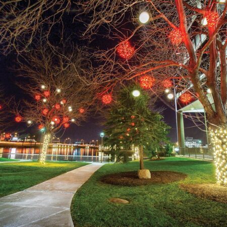 red light globes in trees in front of buildings