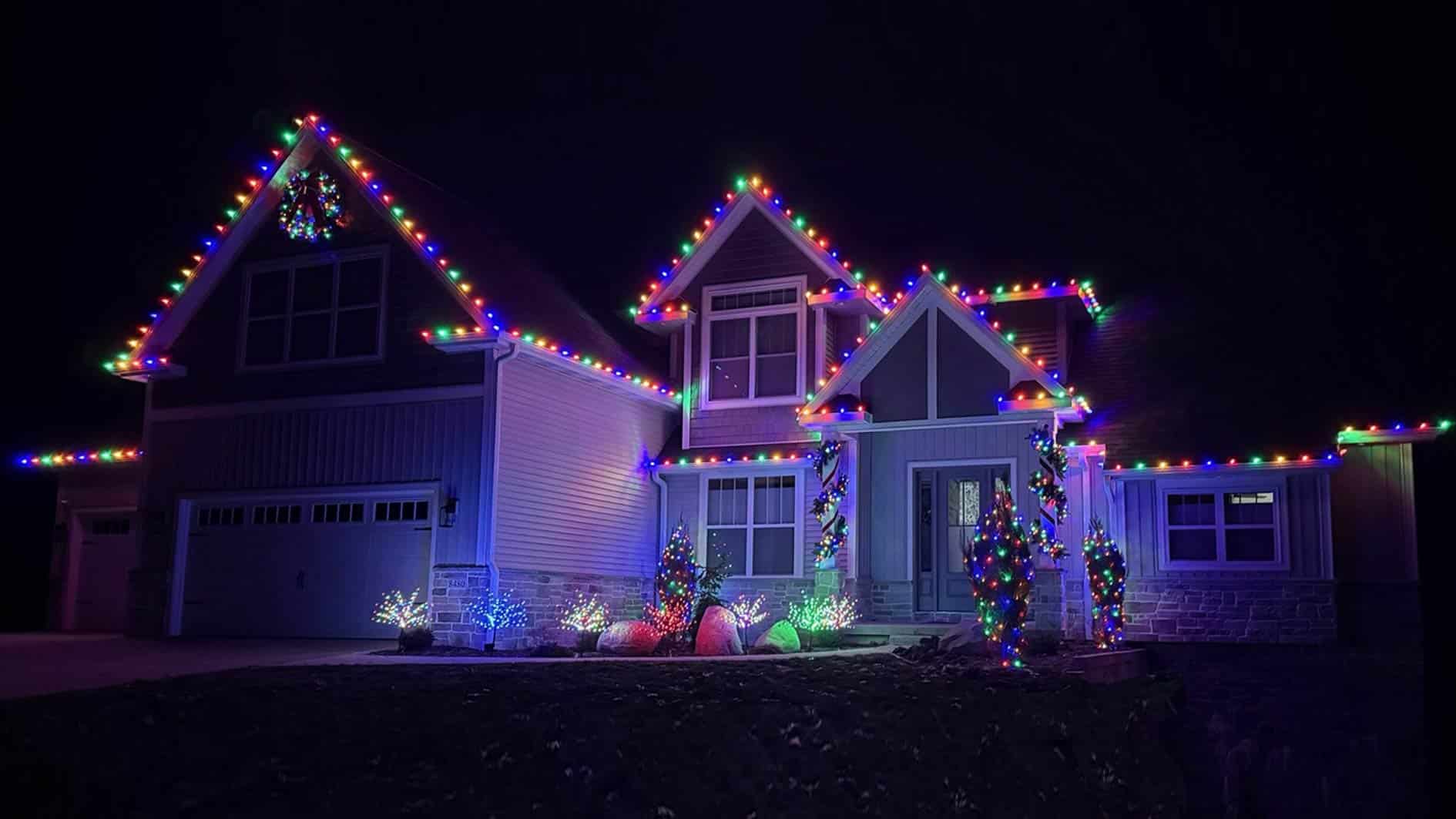purple and multicolored lights on two story home